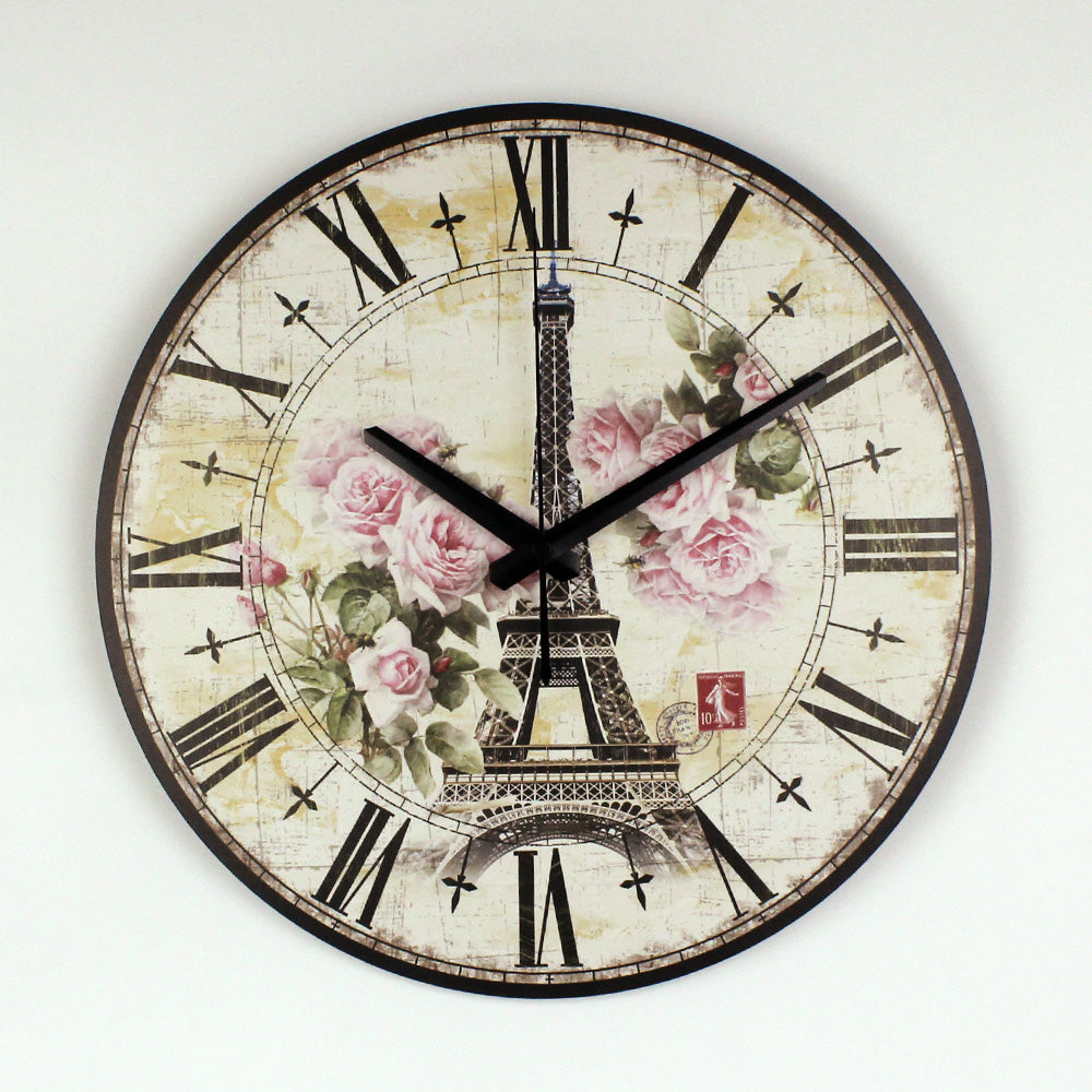 Decorative wall clock with Eiffel Tower and floral design on a white background