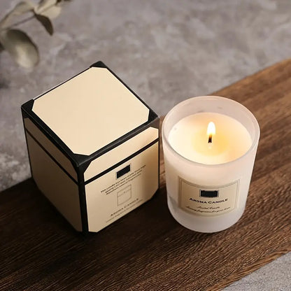 Aroma candle with packaging on a wooden surface