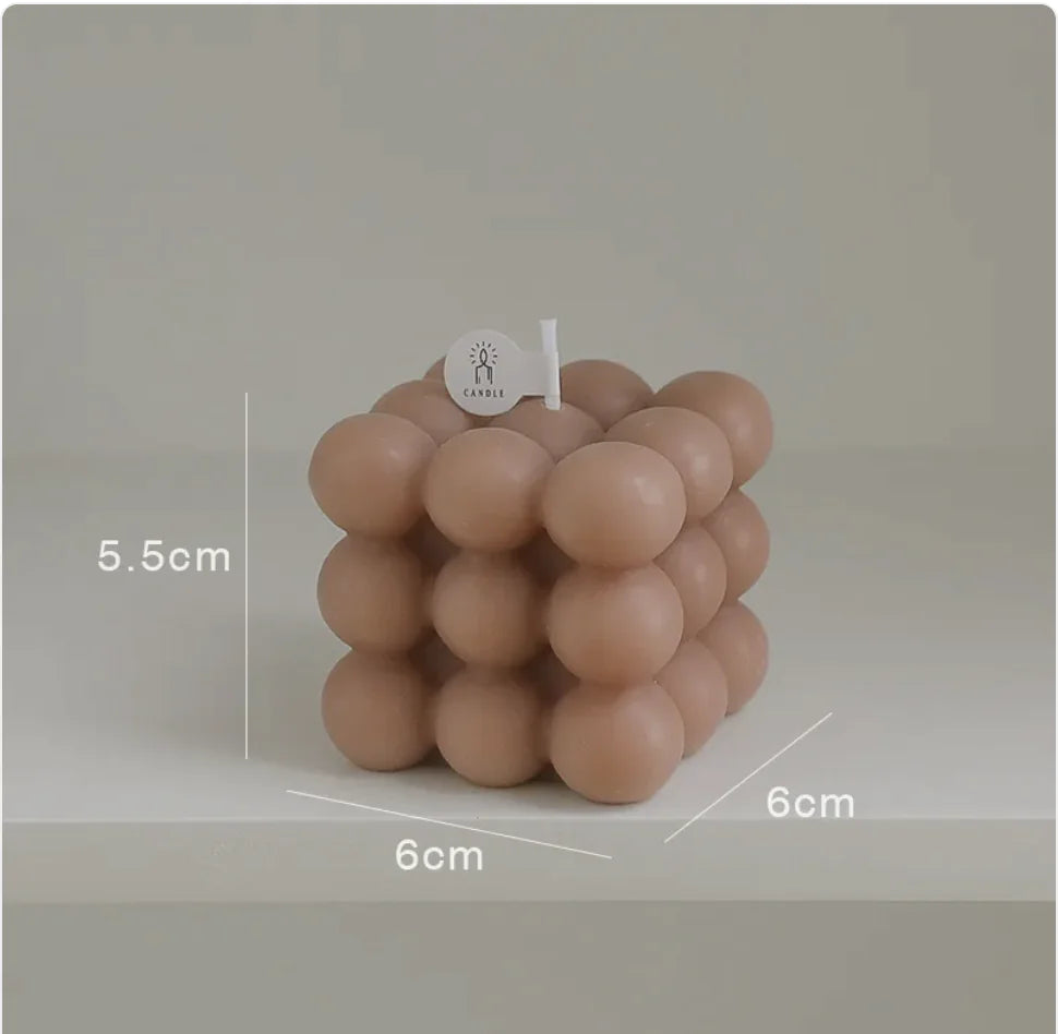 Cylindrical candle with a textured surface and dimensions labeled on a plain background