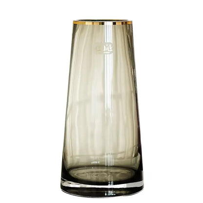 Clear glass vase with gold rim on a white background