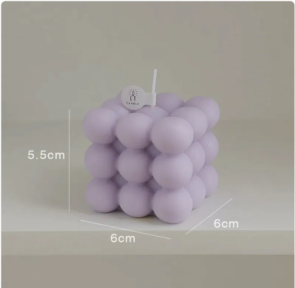Purple bubble candle with measurements on a gray background