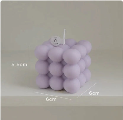 Purple bubble candle with measurements on a gray background