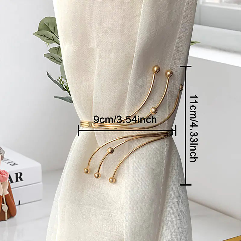 Gold curtain tieback with measurements on a white curtain background