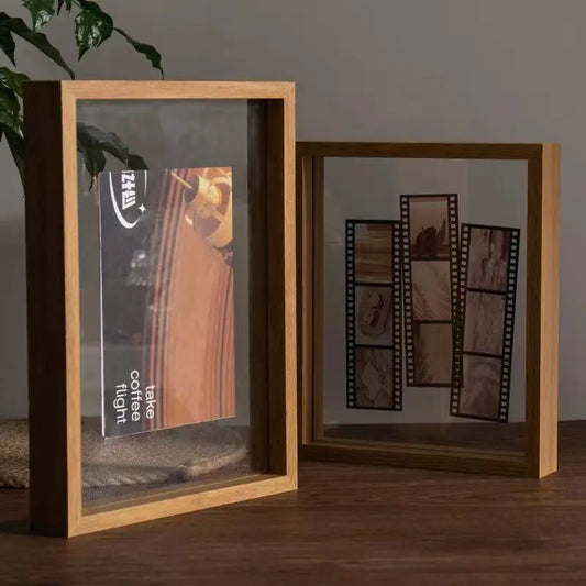Two wooden picture frames on a wooden surface with a neutral background