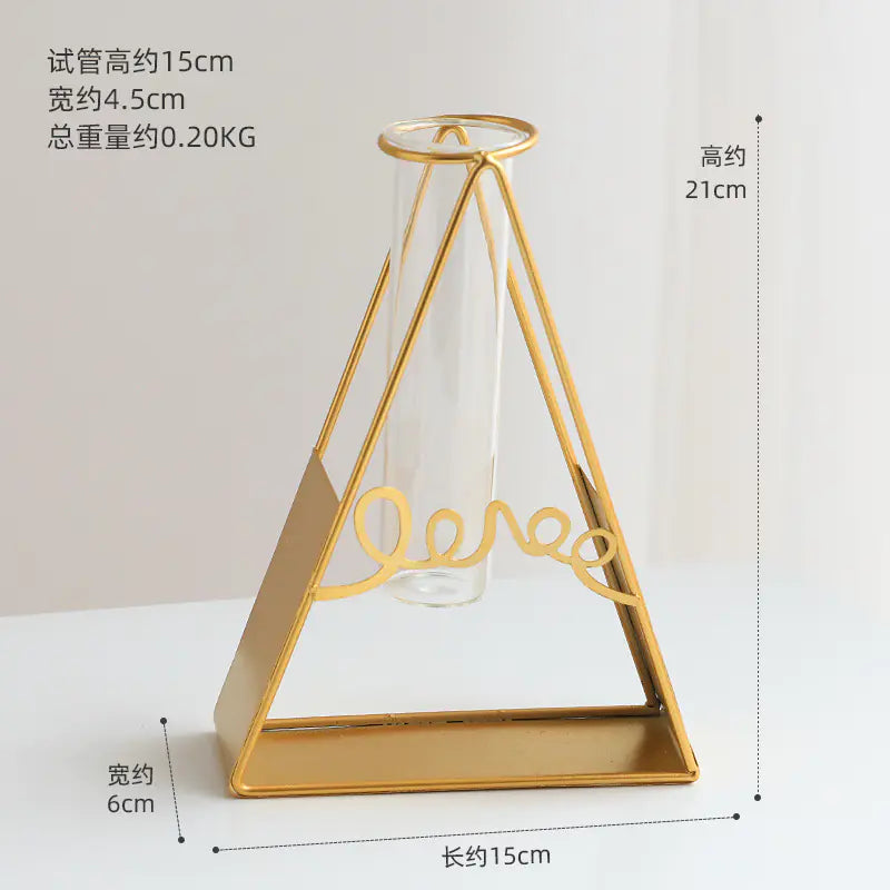 Gold geometric vase with measurements on a white background