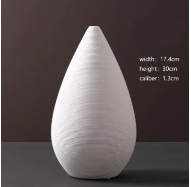 White teardrop-shaped vase on a dark background with measurements displayed.