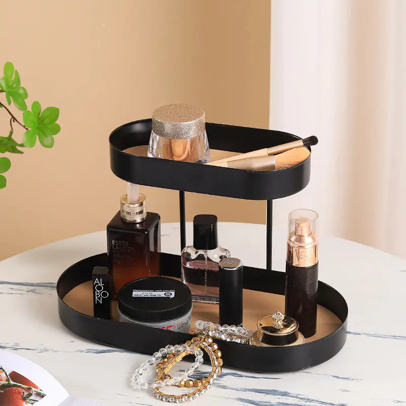 Black two-tiered tray with beauty products on a marble surface