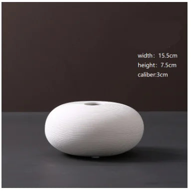 White ceramic vase on a dark background with measurements displayed.