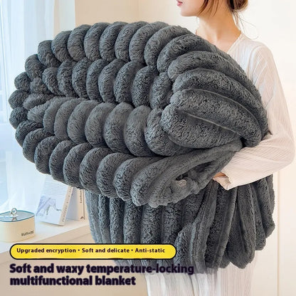 Person holding a large gray blanket with text describing its features.