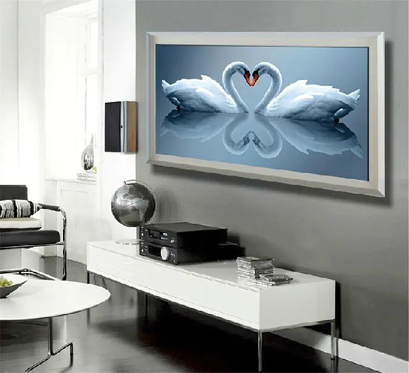 Modern living room with a large TV displaying two swans forming a heart shape.