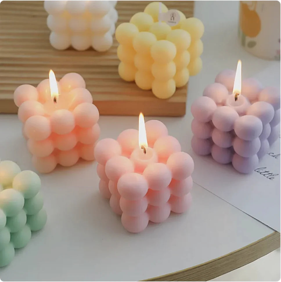 Bubble-style candles in various colors on a flat surface