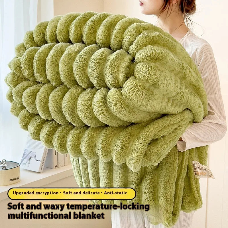 Green blanket being held by a person with product features highlighted