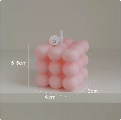 Pink bubble candle with measurements on a gray background
