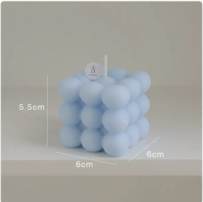Blue bubble candle with dimensions labeled on a neutral background
