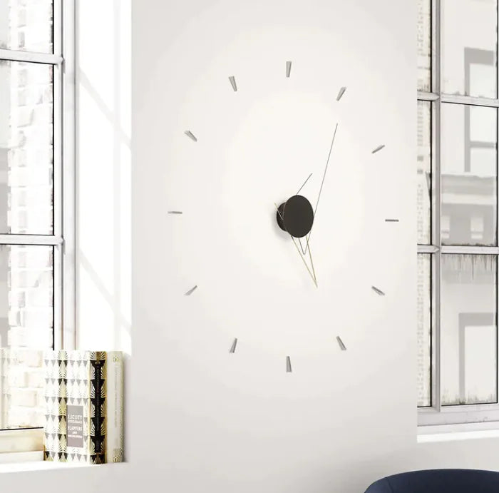 Large wall clock on a white wall with a minimalistic design