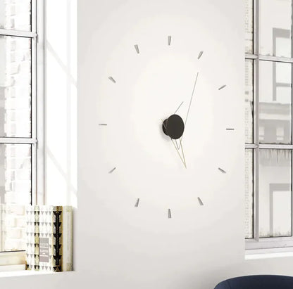 Large wall clock on a white wall with a minimalistic design