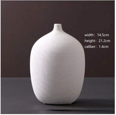 White ceramic vase on a dark surface with measurements displayed.