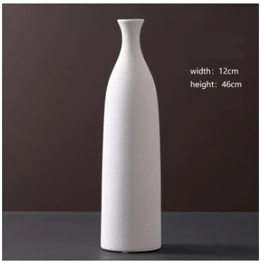 White ceramic vase on a dark background with measurements displayed.
