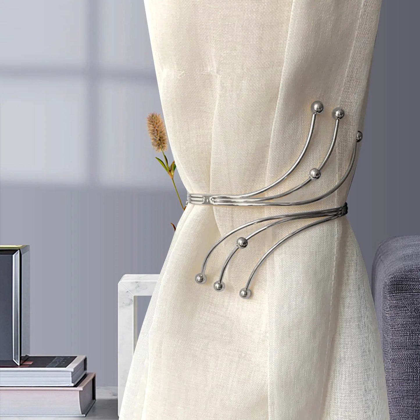 Decorative curtain tieback with floral design on a beige curtain