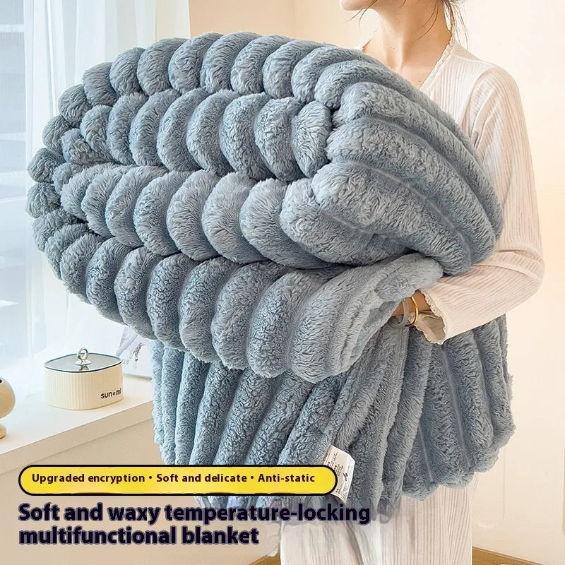 Person holding a large gray blanket with text describing its features.