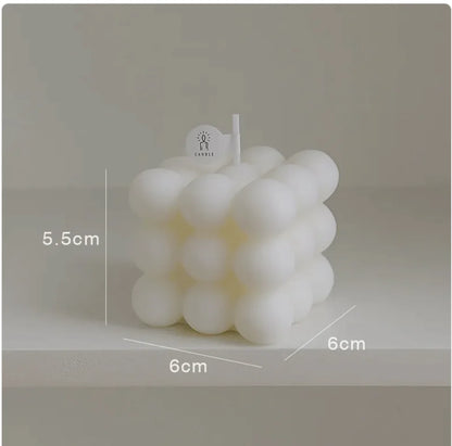White bubble candle with dimensions labeled on a neutral background