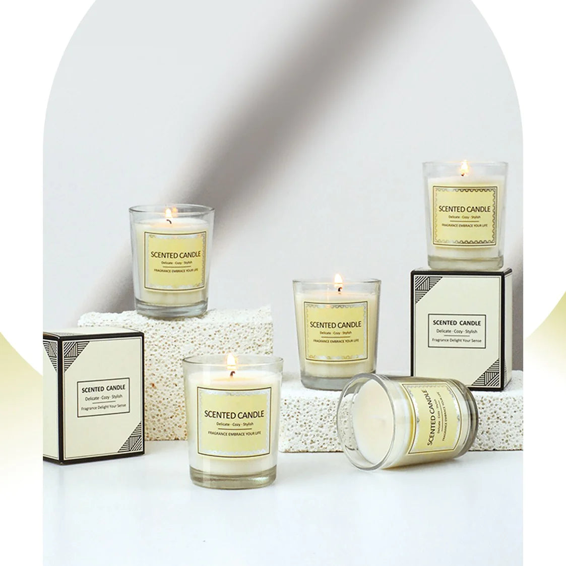 Collection of scented candles with labels on a white surface